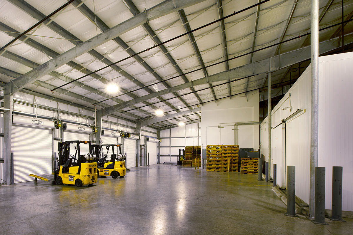 Yellow forklifts parked in front of shutters